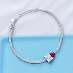 Load image into Gallery viewer, Silver bracelet with a red gemstone on a light blue background
